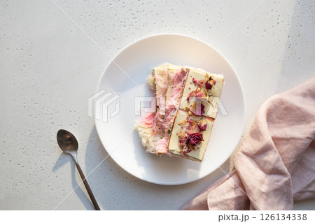 Tasty trendy dessert handicraft chocolate with airy filling white and pink pismaniye on white table. View from above. Lovely morning 126134338