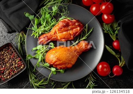 Smoked chicken drumsticks with greens and vegetables. 126134518