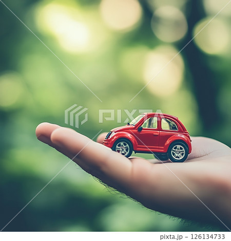 Miniature Red Car Balances Gracefully On Open Hand Palm Miniature Red Car Balances Gracefully On Open Hand Palm 126134733
