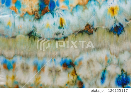 abstract pattern on silk fabric texture in blue, yellow, green colors 126135117