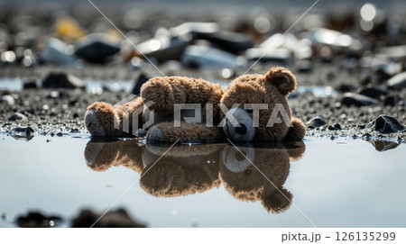 Abandoned teddy bear among trash in a polluted environment 126135299