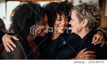 People of various nationalities join in collective hug showing unity and smiling. Diverse assembly consisting of people of all ages races and backgrounds comes for group pose hugging. 126136451