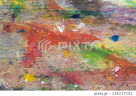 Color splashed wooden palette with layers of acrylic paint, scratches and artistic brush strokes. Concept of painting, creativity and studio process 126137181