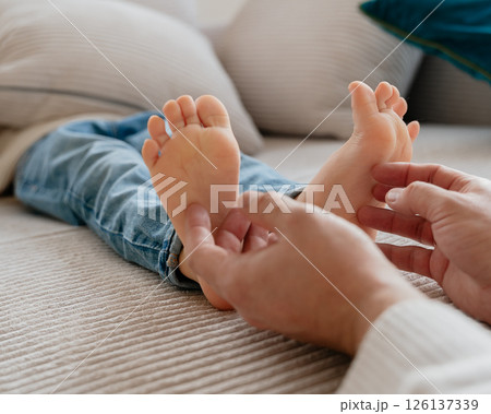 baby feet, boy feet, foot massage, dad tickles son's feet, foot tickling . High quality photo 126137339