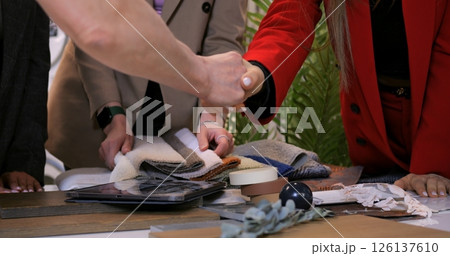 Team circles mood boards, fueling designer synergy where designer viewpoints merge color samples, letting designer imaginations shape robust interior solutions. Successful deal designer 126137610