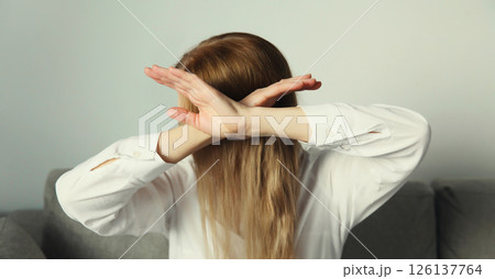 Woman shows stop, no or enough sign with palm of hand, refusal gesture, domestic violence 126137764