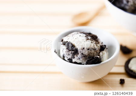 Cookies and cream ice cream in a white bowl. 126140439