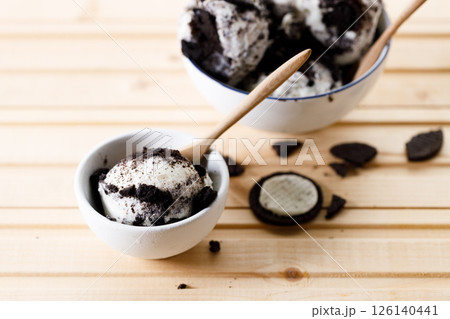 Cookies and cream ice cream in a white bowl. 126140441