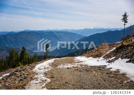 Panoramic view from Mount Kokuya at Teletskoye Ski Resort. Spring landscape with snow and mountains in Altai, Russia 126141334