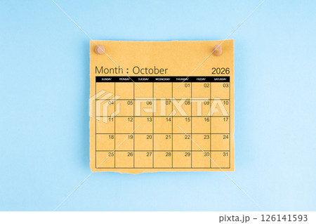 October 2026 brown calendar with wooden thumbtack on blue background. 126141593