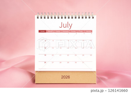 Front view of blank July 2026 desk calendar on pink textile. 126141660