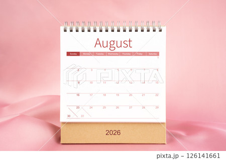 Front view of blank August 2026 desk calendar on pink textile. 126141661