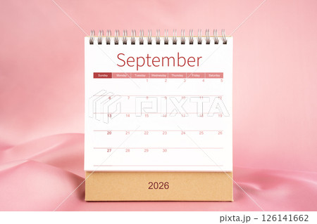 Front view of blank September 2026 desk calendar on pink textile. Front view of blank September 2026 desk calendar on pink textile. 126141662