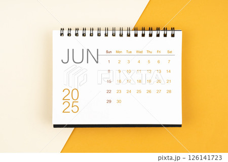 Desk calendar for June 2025 year on yellow background, Flat lay. Desk calendar for June 2025 year on yellow background, Flat lay. 126141723