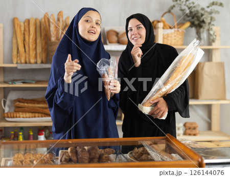 Muslim women customers speaking in bakery 126144076