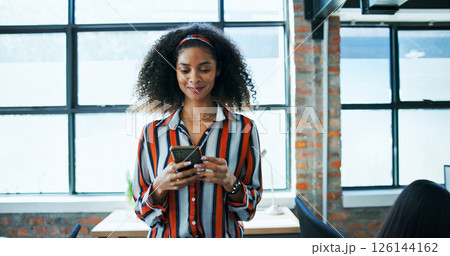 Creative agency, businesswoman and smile with smartphone for message, online news and contact in office. Workplace, female person and worker on break with digital, blog application and social media 126144162
