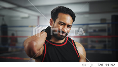 Man, neck pain and stress at gym for boxing by ring for injury, muscle fatigue or frustrated at training center. Person, burnout and athlete with inflammation, mixed martial arts or fitness at club 126144192