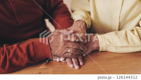 Home, table and old couple with holding hands for empathy, support and comfort to partner with grief. Closeup, senior people and love with sympathy for loss, compassion and kindness with commitment Home, table and old couple with holding hands for empathy, support and comfort to partner with grief. Closeup, senior people and love with sympathy for loss, compassion and kindness with commitment 126144312
