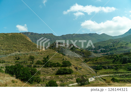 A mountain range with a small village in the valley 126144321
