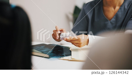 Hands, dentist and model in clinic advice for oral hygiene, teeth whitening and cleaning or checkup. People, discussion and orthodontist for tooth health, cavity search or plaque removal procedure 126144342