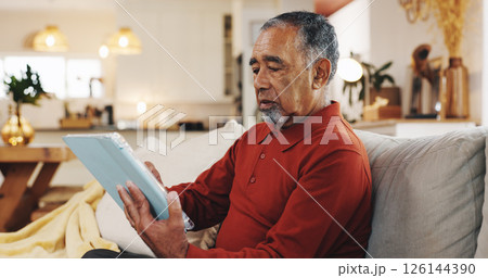 Senior man, tablet and thinking with living room, sofa and reading online news blog post. Relax, digital technology and mature person with app, internet scroll and social media at home for retirement Senior man, tablet and thinking with living room, sofa and reading online news blog post. Relax, digital technology and mature person with app, internet scroll and social media at home for retirement 126144390