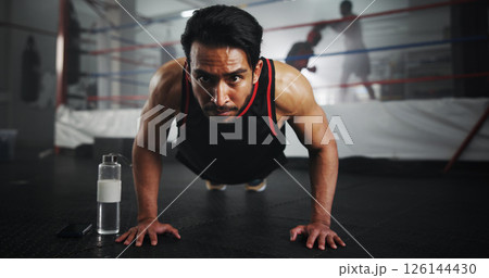Man, push ups and boxer in gym for fitness, warm up or ready for training for match, strength and muscle. Serious, sports and boxing ring with athlete, start or prepare for performance with power 126144430