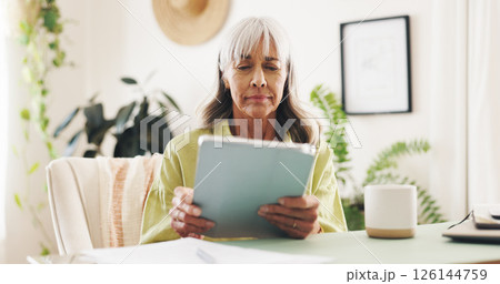 Worry, reading and tablet with old woman at home for retirement fund savings, life insurance payment and anxiety. Tax audit, bankruptcy and loan interest with senior person in apartment for debt 126144759