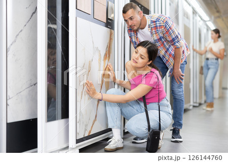 Married couple chooses floor tiles for their home together Married couple chooses floor tiles for their home together 126144760