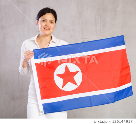 Portrait of positive young woman with flag of North Korea Portrait of positive young woman with flag of North Korea 126144917