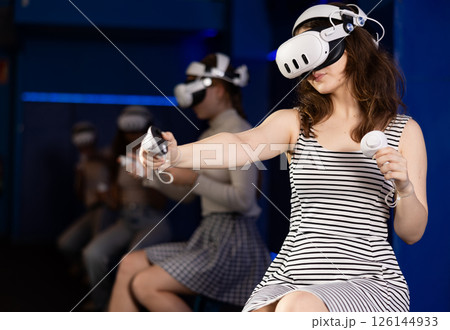 Girls using virtual reality glasses - girlfriends having fun with vr headset 126144933