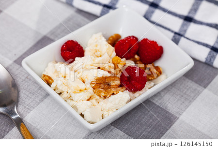 Farm cottage cheese filled with large amount of honey with walnut and raspberry. 126145150