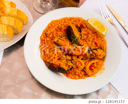 Popular dish of Spanish cuisine is paella with seafood Popular dish of Spanish cuisine is paella with seafood 126145157