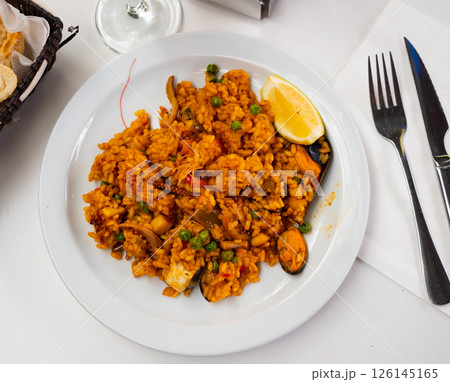 National dish of Spanish cuisine is Paella with seafood 126145165