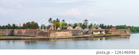 The Mannar Dutch Fort in Sri Lanka stands proudly along the calm waterfront, its weathered stone walls and colonial architecture surrounded by lush palms and a serene sky The Mannar Dutch Fort in Sri Lanka stands proudly along the calm waterfront, its weathered stone walls and colonial architecture surrounded by lush palms and a serene sky 126146098