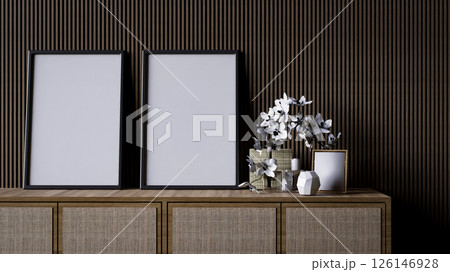 A modern interior scene featuring a wooden console with empty frames and decorative flowers against a textured wall. 126146928