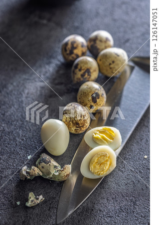 Boiled quail eggs on black table. Boiled quail eggs on black table. 126147051