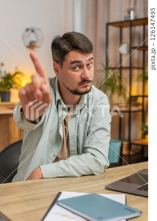 Displeased Caucasian young man freelancer shake finger No sitting at home office desk in living room 126147495