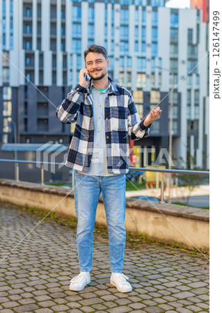 Mature Caucasian man having conversation communicate speaking by smartphone in downtown city street Mature Caucasian man having conversation communicate speaking by smartphone in downtown city street 126147499