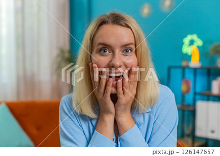 Woman surprised looking at camera with big eyes, shocked by sudden victory good win news celebrating 126147657