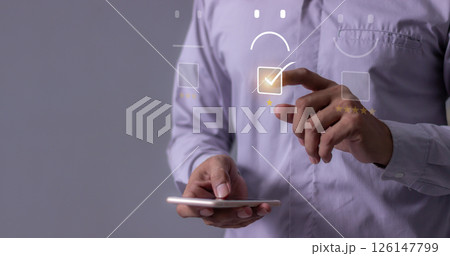 Young man hand holding smartphone to review and gives 1 star, with poor service results Young man hand holding smartphone to review and gives 1 star, with poor service results 126147799