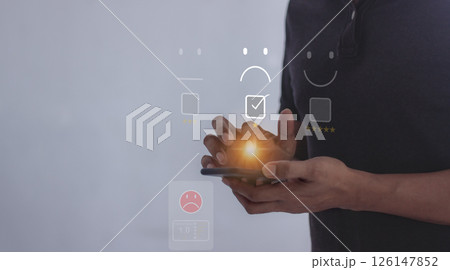 Young man hand holding smartphone to review and gives 1 star 126147852