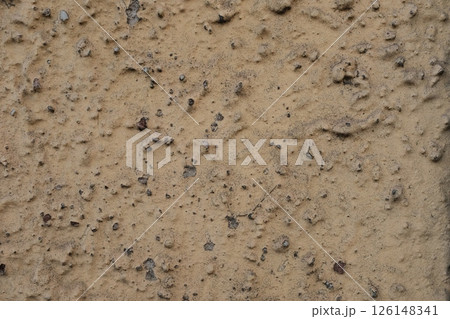 Rough textured natural earth soil background with cracks pebbles organic dirt patterns dry muddy surface close up detail for construction geology agriculture backdrop design. High quality photo 126148341
