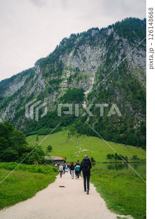 Konigssee Lake in Bavaria Germany with Church by the Lake White Boat Forested Mountain and Beautiful Sunny Trekking in Berchtesgaden German Alps. High quality photo 126148668