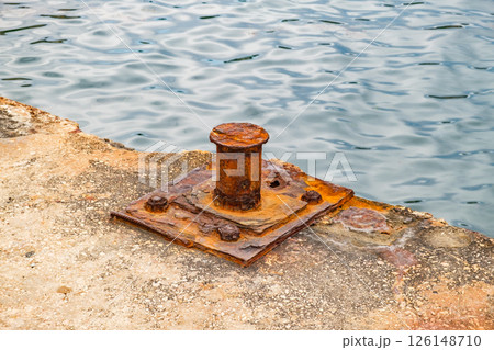 rusty old bollard on concrete pier, close-up 126148710