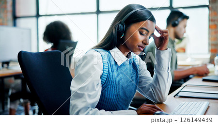 Burnout, headache and stress with woman in call center for assistance, feedback or problem solving. Computer, contact us and frustration with employee in workplace for customer service or support Burnout, headache and stress with woman in call center for assistance, feedback or problem solving. Computer, contact us and frustration with employee in workplace for customer service or support 126149439