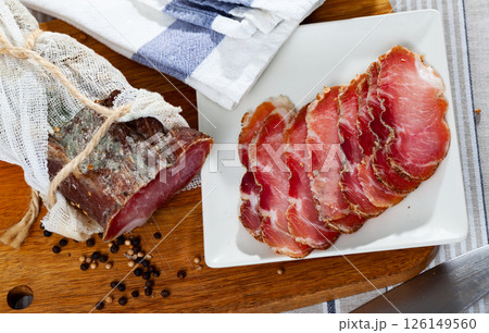 Slices of cured pork tenderloin on cutting board Slices of cured pork tenderloin on cutting board 126149560
