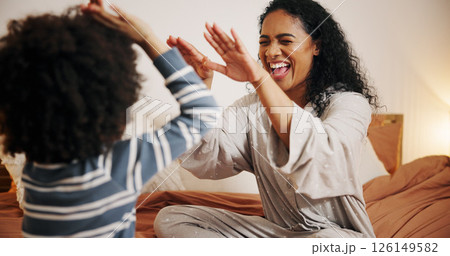 Smile, mom and high five for child, bedroom and excited for fun in house, laughing and game with kid. Happiness, woman and playing with son in home, boy and bonding with mother in apartment or family 126149582
