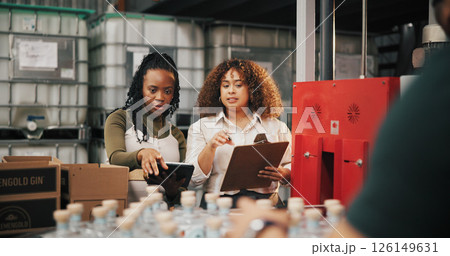 Distillery, check and inspection with women in factory for packaging, drink production and bottle checklist. Manufacturing, inventory and distribution with people in warehouse for quality control 126149631
