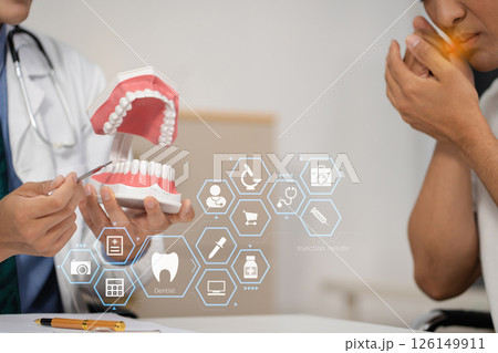Dentist working tooth model, dentistry and recommend patient concept. Dentist working tooth model, dentistry and recommend patient concept. 126149911