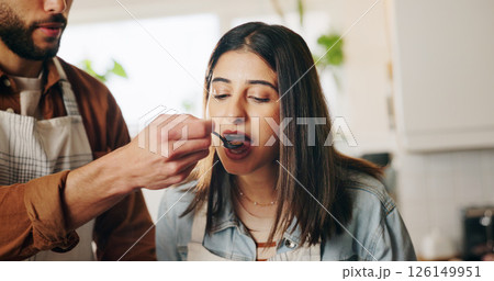 Couple, cooking and taste with spoon in kitchen for meal, test and helping hand for recipe in home. People, man and woman with food, diet and nutrition with feeding, love and bonding at apartment Couple, cooking and taste with spoon in kitchen for meal, test and helping hand for recipe in home. People, man and woman with food, diet and nutrition with feeding, love and bonding at apartment 126149951